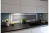 A modern kitchen countertop with a sink, faucet, and under-cabinet lighting. Voir les images du produit