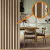 A modern dining area with a wooden table and chairs, set against a kitchen backdrop with marble accents and light green cabinets. Podgląd zdjęcia produktu