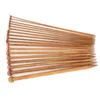 A collection of wooden knitting needles arranged diagonally on a white background. Podgląd zdjęcia produktu