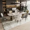 A modern dining room with a marble-top dining table and chairs. Voir les images du produit