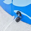 Water is draining from a blue and light blue patterned pool through a black valve onto a light gray surface. Produktbild-Vorschau
