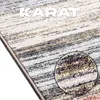 A close-up view of a rug with a textured detail shown in a circular inset. Náhled obrázku produktu