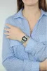 A person wearing a blue polka dot shirt and a silver digital watch. Produktbild-Vorschau