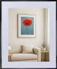 A framed picture of a red poppy on a blue background hangs above a sofa in a living room. Produktbild-Vorschau