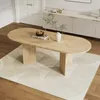 A modern dining room with an oval wooden table and a sideboard in the background. Náhľad obrázku produktu