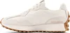 A side view of a beige New Balance sneaker with a brown sole. Voir les images du produit