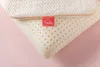 Close-up of a pillow with a red tag. Produktbild-Vorschau