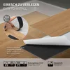 Close-up of vinyl flooring planks being installed, with text overlays highlighting features. Produktbild-Vorschau