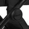 A close-up view of the black frame of a stroller, showing the brand logo. Produktbild-Vorschau
