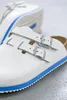 A close-up shot of white Birkenstock sandals with blue trim. Produktbild-Vorschau