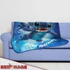 A blanket with a Lilo & Stitch design is draped over a sofa. Anteprima dell’immagine prodotto