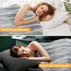 Two split images showing women sleeping under a gray blanket. Produktbild-Vorschau