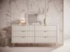 A modern dresser with decorative elements in a room with marble-patterned walls. Produktbild-Vorschau
