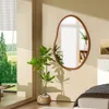 A bedroom scene with a mirror, plant, and bed. Produktbild-Vorschau