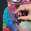 A hand is placing a puzzle piece into a larger wooden puzzle of a cat. Náhľad obrázku produktu
