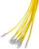 A group of small, clear light bulbs with yellow wires attached, isolated on a white background. Produktbild-Vorschau