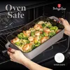 A person is taking a baking dish filled with pasta, shrimp, and broccoli out of an oven. Náhled obrázku produktu