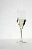 A single glass of champagne on a white surface. Produktbild-Vorschau