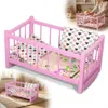 Ein Puppenbett aus Holz, eine rosa Wiege mit grauer Produktbild-Vorschau 1