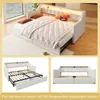 A collage of images showing a white upholstered bed with a built-in headboard featuring LED lighting. The bed is shown in its assembled state with bedding and pillows, and also in its extended state revealing the pull-out mattress base and drawers. Voir les images du produit