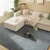 A living room scene with a sectional sofa, a rug, and a cat. Náhled obrázku produktu
