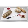 A white cutting board with bread, raspberries, and a knife. Produktbild-Vorschau