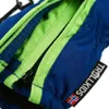 Close-up of a blue glove with a green zipper detail and a brand tag. Produktbild-Vorschau