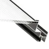 A close-up, angled view of a section of a greenhouse structure, showing the interlocking polycarbonate panels and aluminum frame. Produktbild-Vorschau