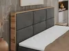 A close-up view of a bed with a dark gray upholstered headboard and a wooden frame. Produktbild-Vorschau