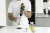 A person is using an immersion blender in a kitchen. Podgląd zdjęcia produktu