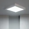 A square LED ceiling light is mounted on a gray ceiling, with two white walls visible below. Produktbild-Vorschau