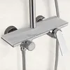 A close-up of a chrome shower faucet with a white marble-look backplate. Produktbild-Vorschau