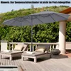 A patio scene with two lounge chairs and a large double umbrella. Podgląd zdjęcia produktu