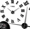 A close-up view of a large, modern wall clock with Roman numerals and black hands. Náhled obrázku produktu