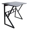 A black gaming computer desk with a metal frame, shown from a three-quarter angle against a white background. Náhled obrázku produktu
