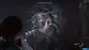 A character in a video game is aiming a weapon at a monstrous creature in a dark, dimly lit environment. Produktbild-Vorschau
