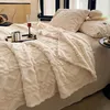 A cozy bed with a thick, textured beige blanket draped over it, featuring a glass of red liquid and a small tray with a decorative item. Anteprima dell’immagine prodotto