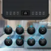 A close-up of a portable air conditioner's control panel with illuminated icons and a digital display, set against a blurred background of a living room. Produktbild-Vorschau