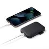 A smartphone is being charged by a power bank. Anteprima dell’immagine prodotto