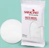A white ball of modeling paste next to its packaging. Produktbild-Vorschau