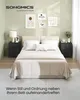 A bedroom scene with a bed, nightstands, and wall art. Produktbild-Vorschau
