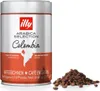 A can of illy Arabica Selection Colombia coffee beans is shown next to a pile of coffee beans. Produktbild-Vorschau