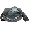 The inside of a dark gray shoulder bag is shown, with the zipper open. Produktbild-Vorschau