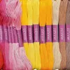 A collection of embroidery floss skeins in various shades of pink, yellow, orange, beige, and brown. Náhled obrázku produktu