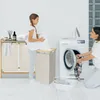 A mother and daughter are doing laundry together in a bright, modern laundry room. The daughter is holding a pile of white clothes, and the mother is loading laundry into a washing machine. Voir les images du produit