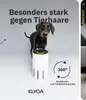 A Doberman dog stands next to a white air purifier with a yellow ring on top. The background is a light gray. Text and graphics highlight the product's features. Produktbild-Vorschau