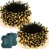 Two coils of warm white LED string lights with green battery boxes in front. Produktbild-Vorschau