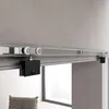 A close-up view of a sliding glass door system, showing the track and roller mechanism. Voir les images du produit