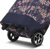 A close-up view of the bottom part of a floral patterned shopping trolley, showing its wheels and base. Náhľad obrázku produktu