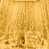 A bed decorated with feather string lights and pillows. Produktbild-Vorschau